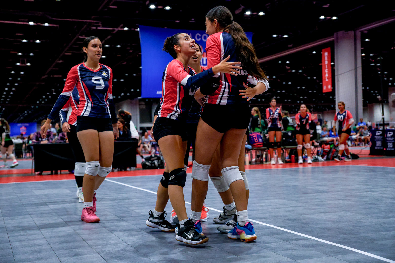 C+A volleyball players hugging after winning a point